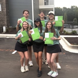 a group of residents posing outdoors