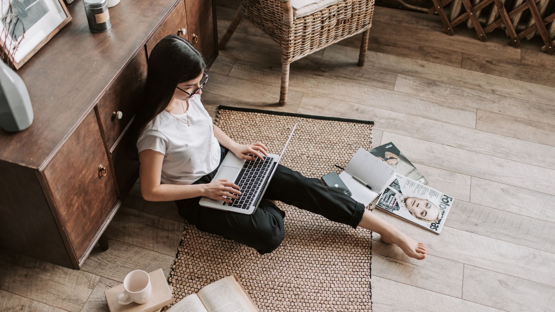 student sitting on the floor of her apartment
