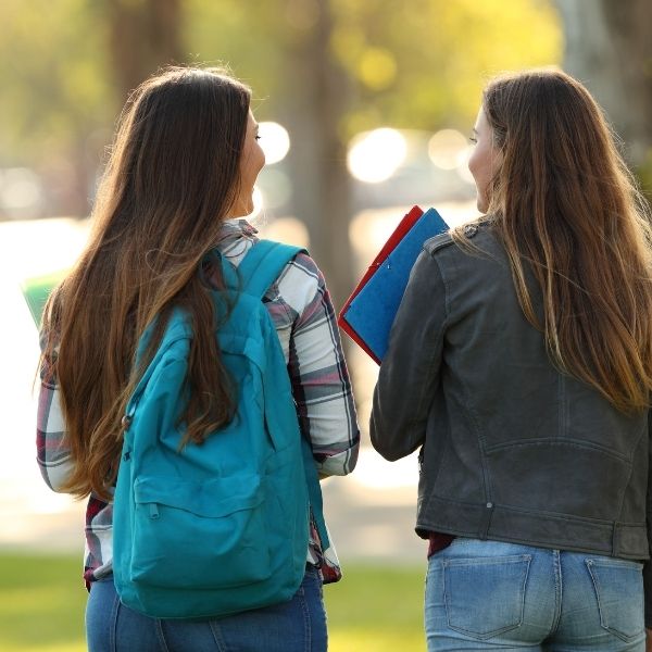 Two college friends talking.