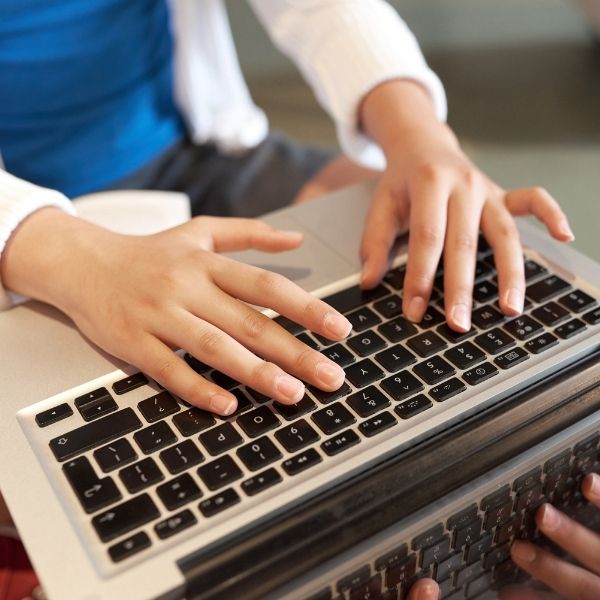 Woman typing on a computer