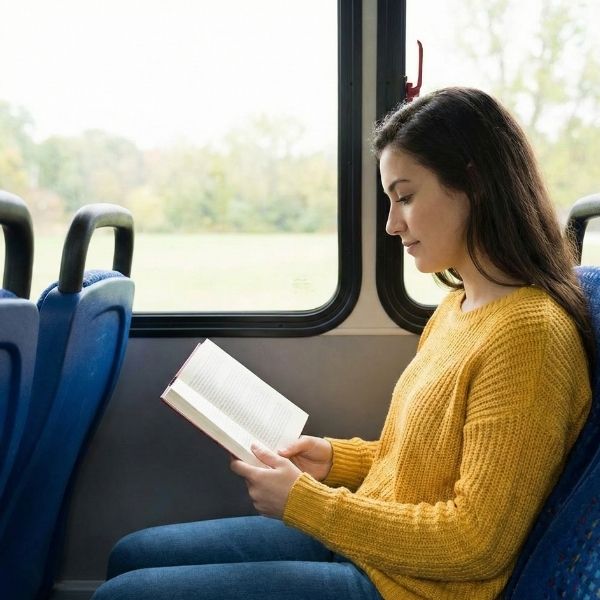 student reading book on shuttle